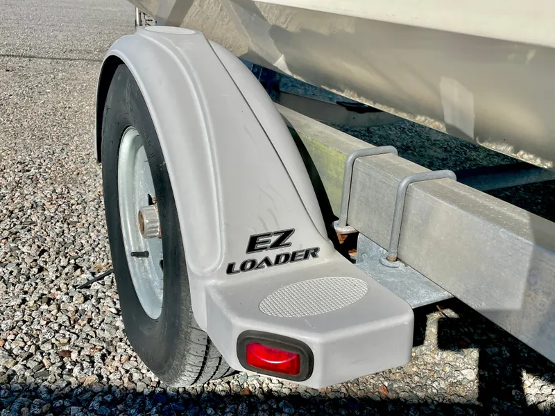Slide: The Image of Trailer wheel of a 2015 Carolina Skiff 178 DLV with EZ Loader branding. - 38
