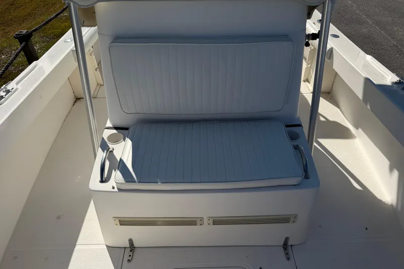 Slide: The Image of 2006 Shamrock 220 Stalker boat on trailer, parked near a showroom under clear blue sky. - 11