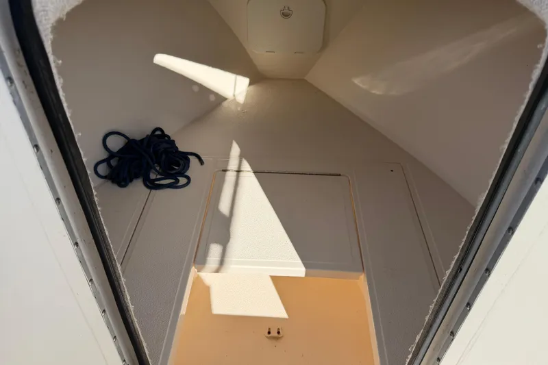 Slide: The Image of 2006 Shamrock 220 Stalker boat interior with white seating and steering wheel. - 12