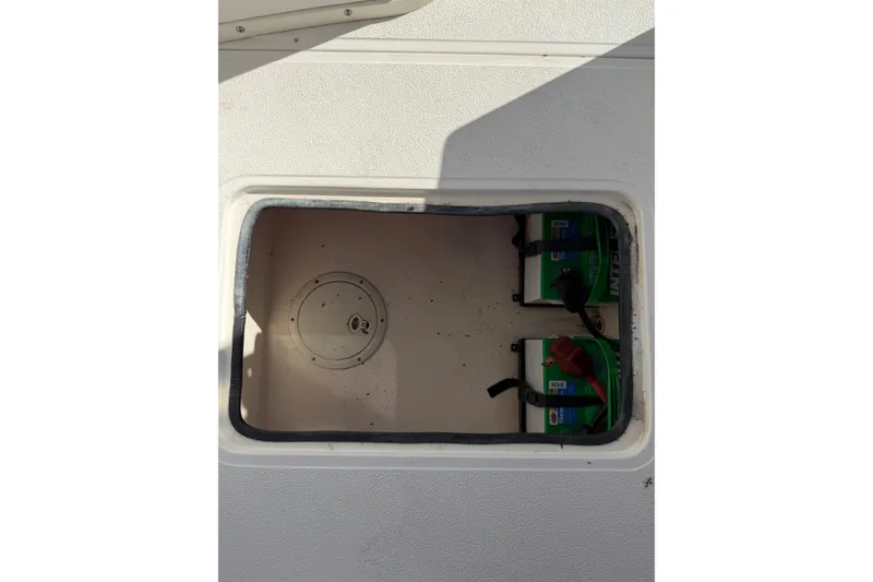 Slide: The Image of Livewell compartment on a 2006 Shamrock 220 Stalker boat, open with lid partially removed. - 13