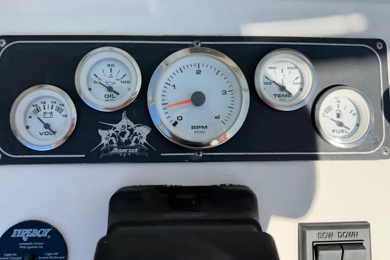 Slide: The Image of Control panel of a 2006 Shamrock 220 Stalker boat with various switches and keys. - 19