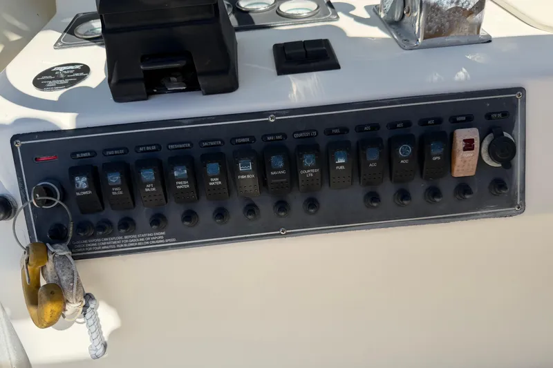 Slide: The Image of Dashboard of a 2006 Shamrock 220 Stalker boat with gauges for oil, RPM, temperature, and fuel. - 20