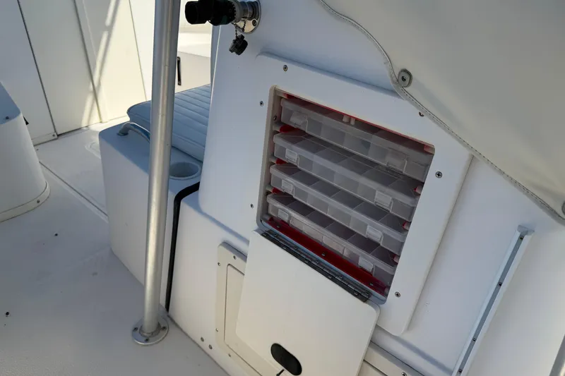 Slide: The Image of Engine compartment of a 2006 Shamrock 220 Stalker boat, showing hoses and components. - 27