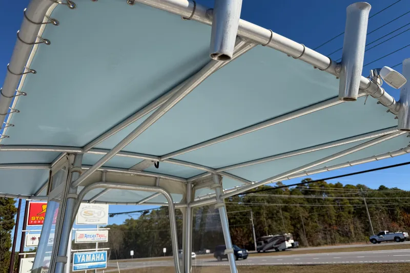 Slide: The Image of T-top of 2006 Shamrock 220 Stalker boat at marina service center, clear sky background. - 31