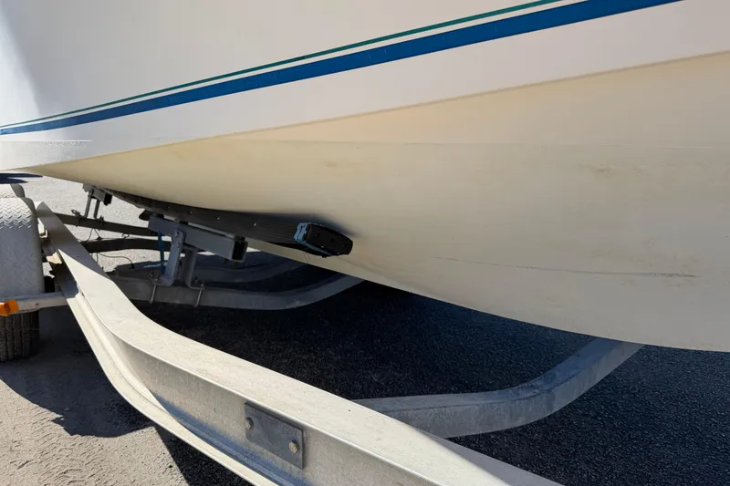 Slide: The Image of T-top of 2006 Shamrock 220 Stalker boat with rod holders, under clear blue sky. - 33