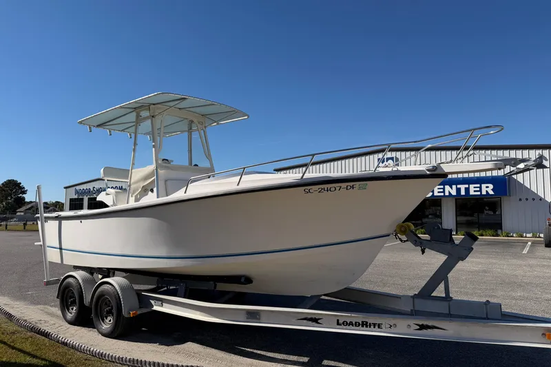 Slide: The Image of 2006 Shamrock 220 Stalker boat on trailer under clear blue sky. - 5