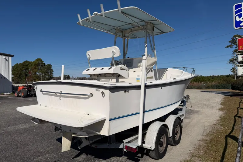 Slide: The Image of 2006 Shamrock 220 Stalker boat on trailer, parked outdoors under clear sky. - 6