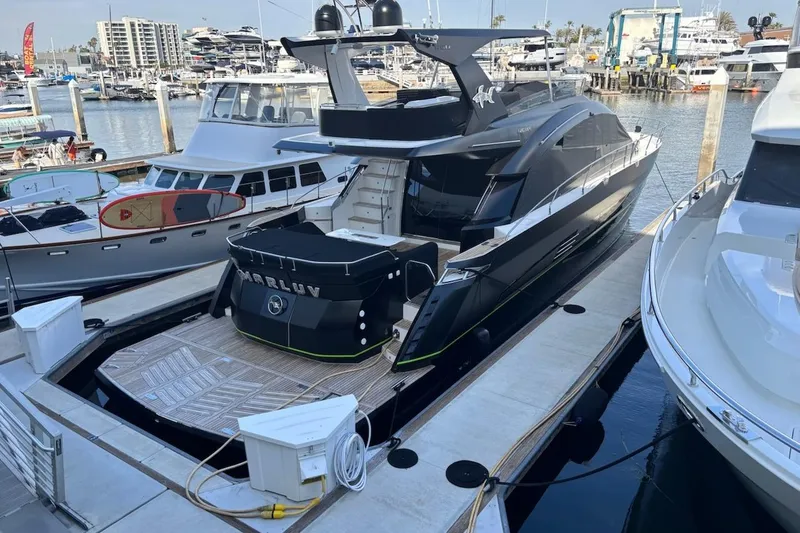 The Image of Luxury 2016 Galeon 660 Flybridge yacht docked at marina, showcasing sleek design. - 0