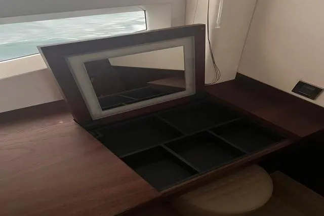 Slide: The Image of Vanity area with mirror and storage on 2016 Galeon 660 Flybridge yacht. - 11