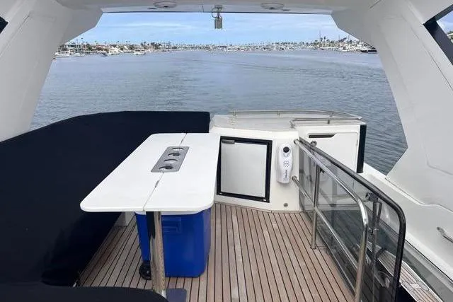 Slide: The Image of Flybridge view of 2016 Galeon 660 yacht with sleek deck and ocean backdrop. - 17