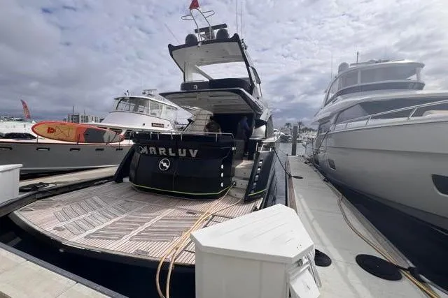 Slide: The Image of Galeon 660 Flybridge 2016 yacht docked at marina, showcasing sleek design and spacious deck. - 2