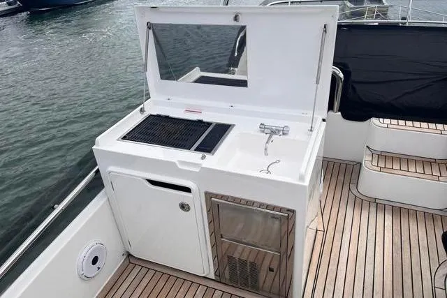 Slide: The Image of Outdoor kitchen on 2016 Galeon 660 Flybridge yacht with grill and sink. - 20