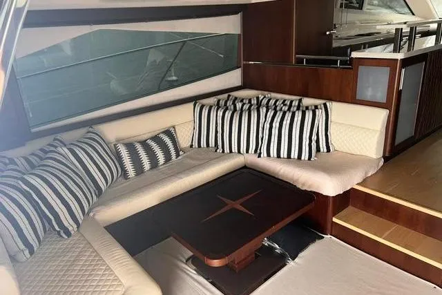 Slide: The Image of Luxurious interior of 2016 Galeon 660 Flybridge yacht with elegant seating and striped cushions. - 26