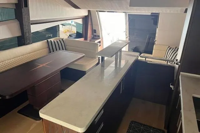 Slide: The Image of Luxurious interior of 2016 Galeon 660 Flybridge yacht with modern seating and dining area. - 28