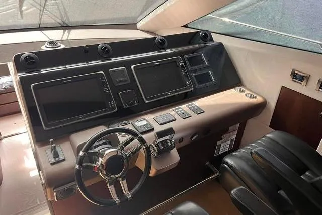 Slide: The Image of Cockpit of 2016 Galeon 660 Flybridge yacht with modern navigation controls and steering wheel. - 31