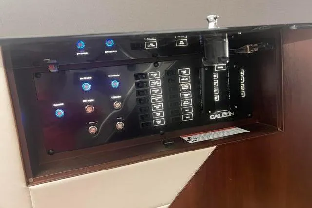 Slide: The Image of Control panel of 2016 Galeon 660 Flybridge yacht with illuminated buttons and switches. - 33