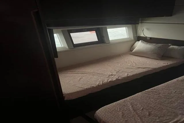 Slide: The Image of Interior cabin of 2016 Galeon 660 Flybridge yacht with bed and window view. - 35