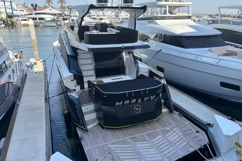 Slide: The Image of Luxury 2016 Galeon 660 Flybridge yacht docked at marina. - 4