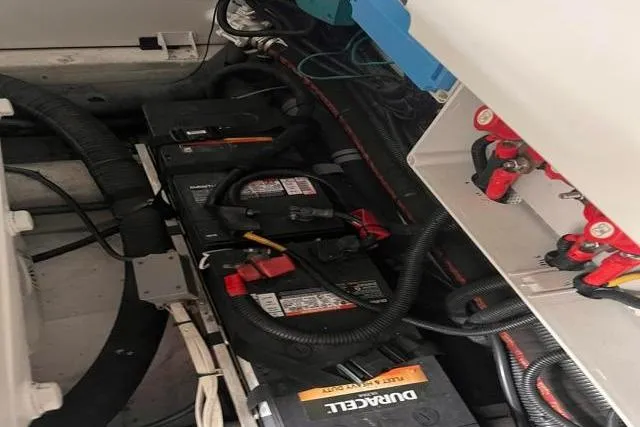 Slide: The Image of Engine compartment of a 2016 Galeon 660 Flybridge with visible batteries and wiring. - 47