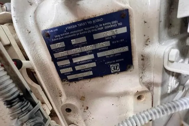 Slide: The Image of Engine plate of a 2016 Galeon 660 Flybridge, showing maintenance details and specifications. - 53