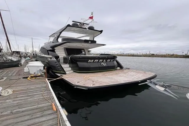 Slide: The Image of Luxury 2016 Galeon 660 Flybridge yacht docked at marina. - 6