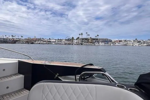 Slide: The Image of 2016 Galeon 660 Flybridge yacht with coastal view and cloudy sky. - 9