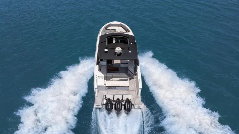 Slide: The Image of 2020 Cruisers Yachts 38 GLS OB speeding on open water, aerial view. - 10