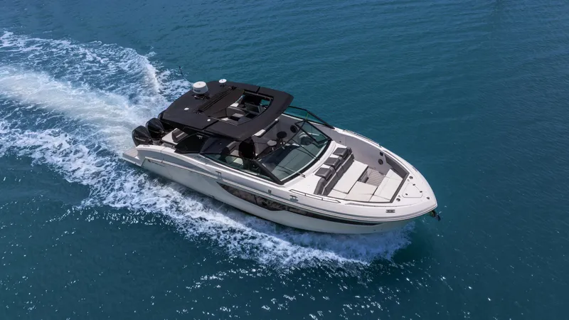 Slide: The Image of 2020 Cruisers Yachts 38 GLS OB cruising on clear blue water. - 2