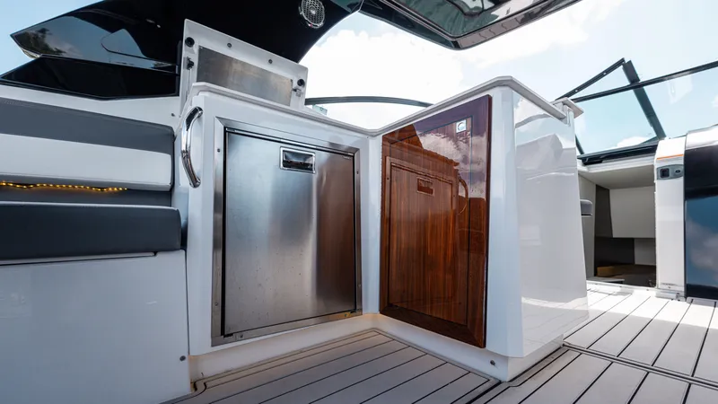 Slide: The Image of Luxury yacht interior with sleek cabinetry, featuring stainless steel and wood finishes, 2020 Cruisers Yachts 38 GLS OB. - 21