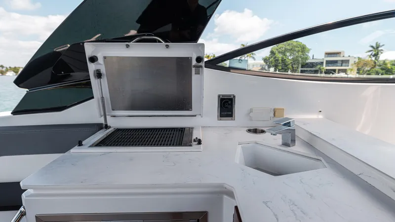 Slide: The Image of 2020 Cruisers Yachts 38 GLS OB outdoor kitchen with grill and sink. - 22