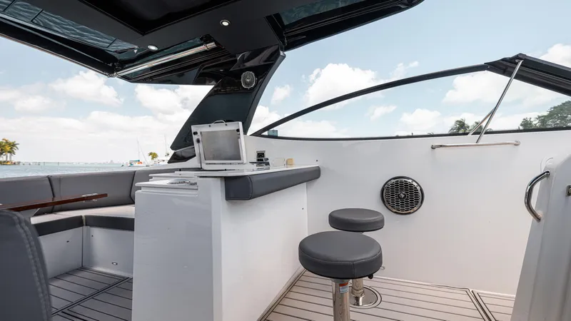 Slide: The Image of 2020 Cruisers Yachts 38 GLS OB interior with seating, table, and open-air design. - 24