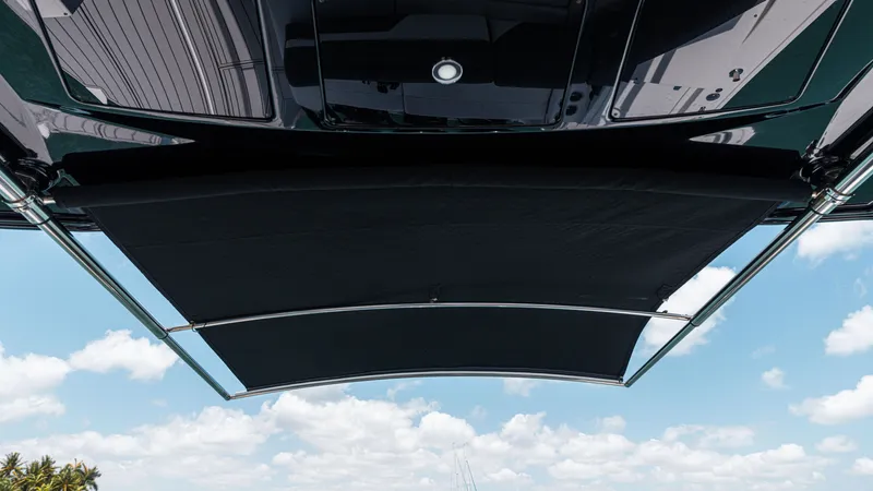 Slide: The Image of 2020 Cruisers Yachts 38 GLS OB canopy against a blue sky with clouds. - 35