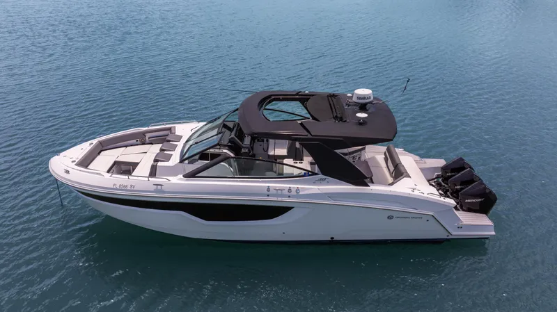 Slide: The Image of 2020 Cruisers Yachts 38 GLS OB on calm blue water, showcasing sleek design and luxury features. - 4