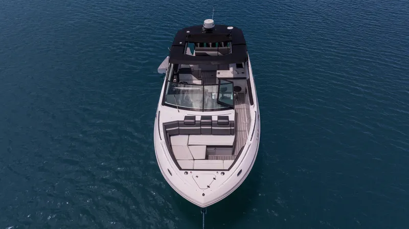 Slide: The Image of 2020 Cruisers Yachts 38 GLS OB on calm blue water, aerial view. - 6