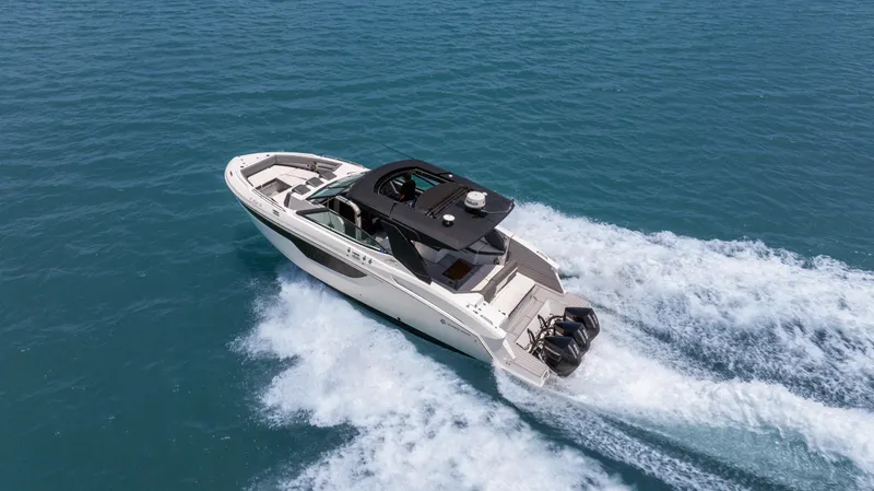 Slide: The Image of 2020 Cruisers Yachts 38 GLS OB speeding on open water, aerial view. - 1
