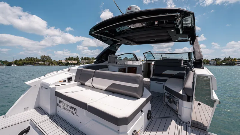 Slide: The Image of 2020 Cruisers Yachts 38 GLS OB on water, featuring spacious seating and sleek design. - 15