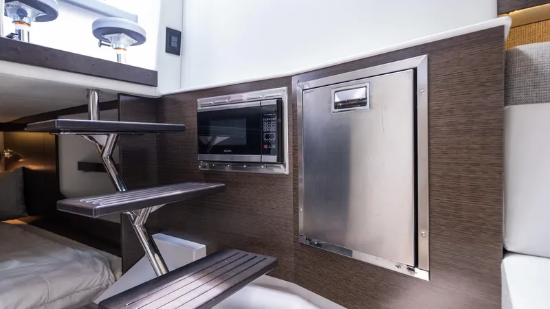 Slide: The Image of Interior of 2020 Cruisers Yachts 38 GLS OB with modern kitchenette and sleek design. - 40