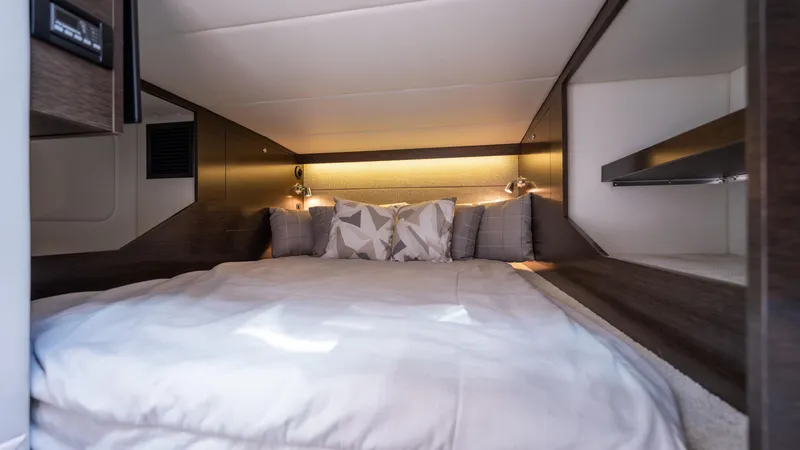 Slide: The Image of Luxurious cabin interior of 2020 Cruisers Yachts 38 GLS OB with cozy bedding and ambient lighting. - 42