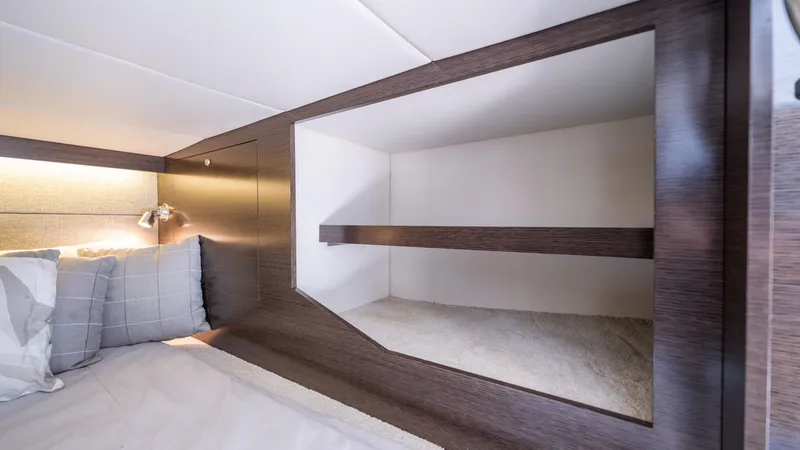 Slide: The Image of 2020 Cruisers Yachts 38 GLS OB cabin interior with modern shelving and cozy bedding. - 43