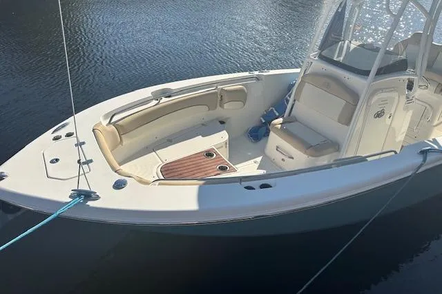 Slide: The Image of 2018 NauticStar 2602 Legacy boat docked on calm water. - 10