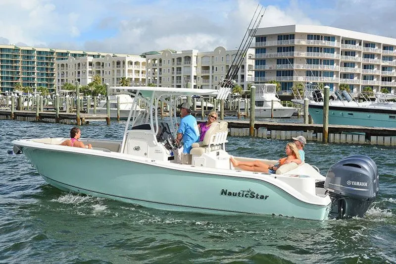 Slide: The Image of Manufacturer Provided Image: 2018 NauticStar 2602 Legacy boat cruising near marina with passengers. - 14