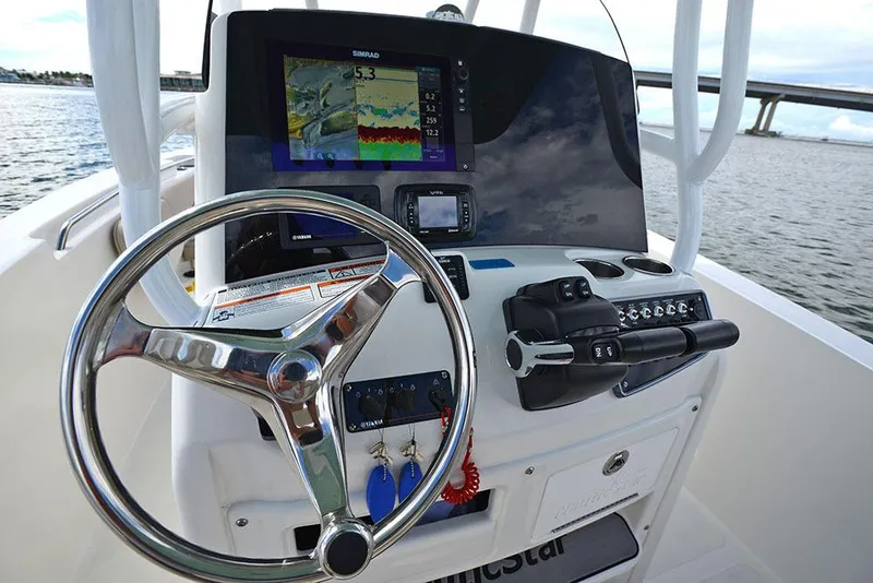Slide: The Image of Manufacturer Provided Image: 2018 NauticStar 2602 Legacy boat dashboard with steering wheel and navigation system. - 16