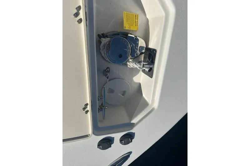 Slide: The Image of 2018 NauticStar 2602 Legacy boat anchor compartment with rope and cleat. - 23