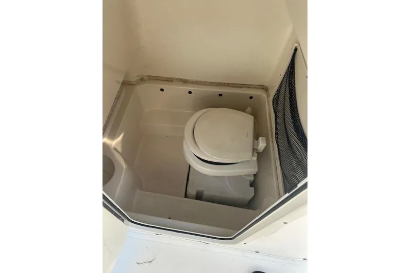 Slide: The Image of 2018 NauticStar 2602 Legacy boat interior with compact marine toilet. - 27