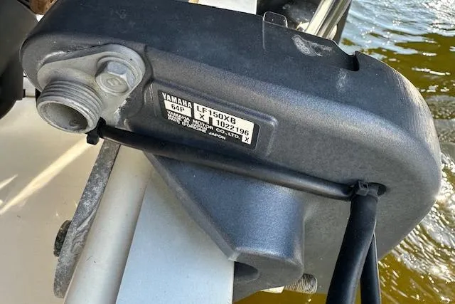 Slide: The Image of Yamaha LF150X8 engine part on 2018 NauticStar 2602 Legacy boat, docked by water. - 30