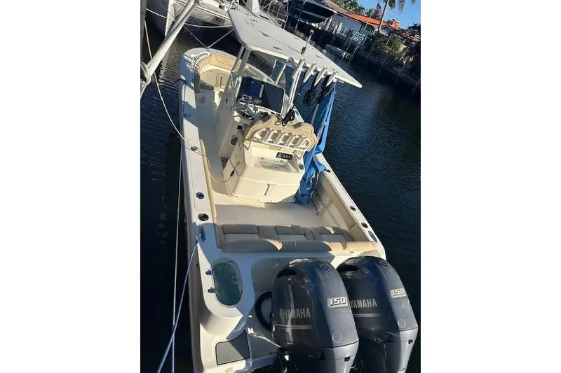 Slide: The Image of 2018 NauticStar 2602 Legacy boat with dual Yamaha engines docked in marina. - 38