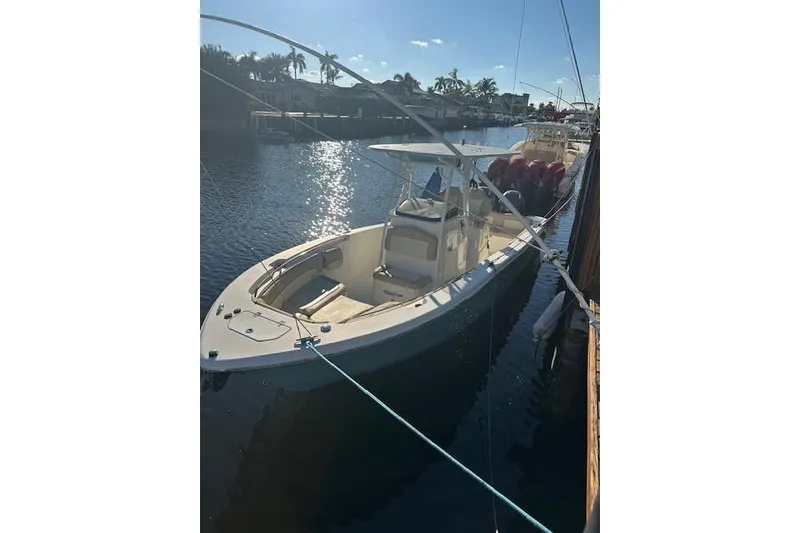 Slide: The Image of 2018 NauticStar 2602 Legacy boat docked in a sunny marina. - 39