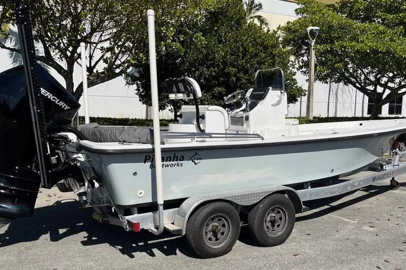 Slide: The Image of 2022 Piranha Alem F2000 boat on trailer, parked outdoors, side view. - 14
