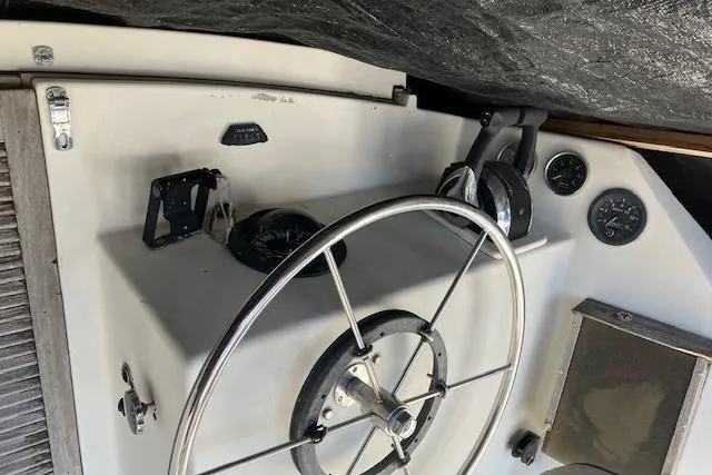 Slide: The Image of Interior of 1981 Witness Catamaran with sink, cleaning supplies, and exposed wiring. - 14