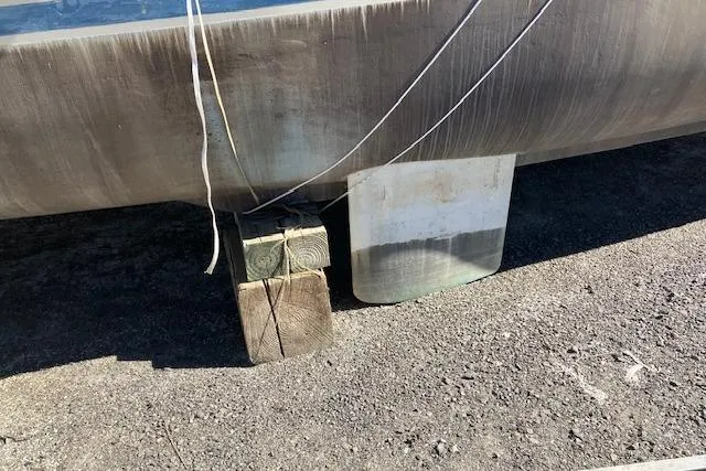 Slide: The Image of 1981 Witness Catamaran on dry dock, showcasing dual hulls and covered components. - 3